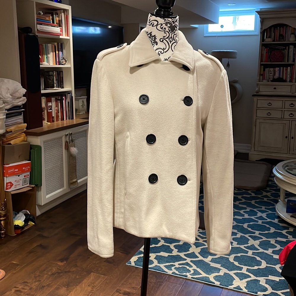 Tommy Hilfiger cream colored pea coat with black buttons.